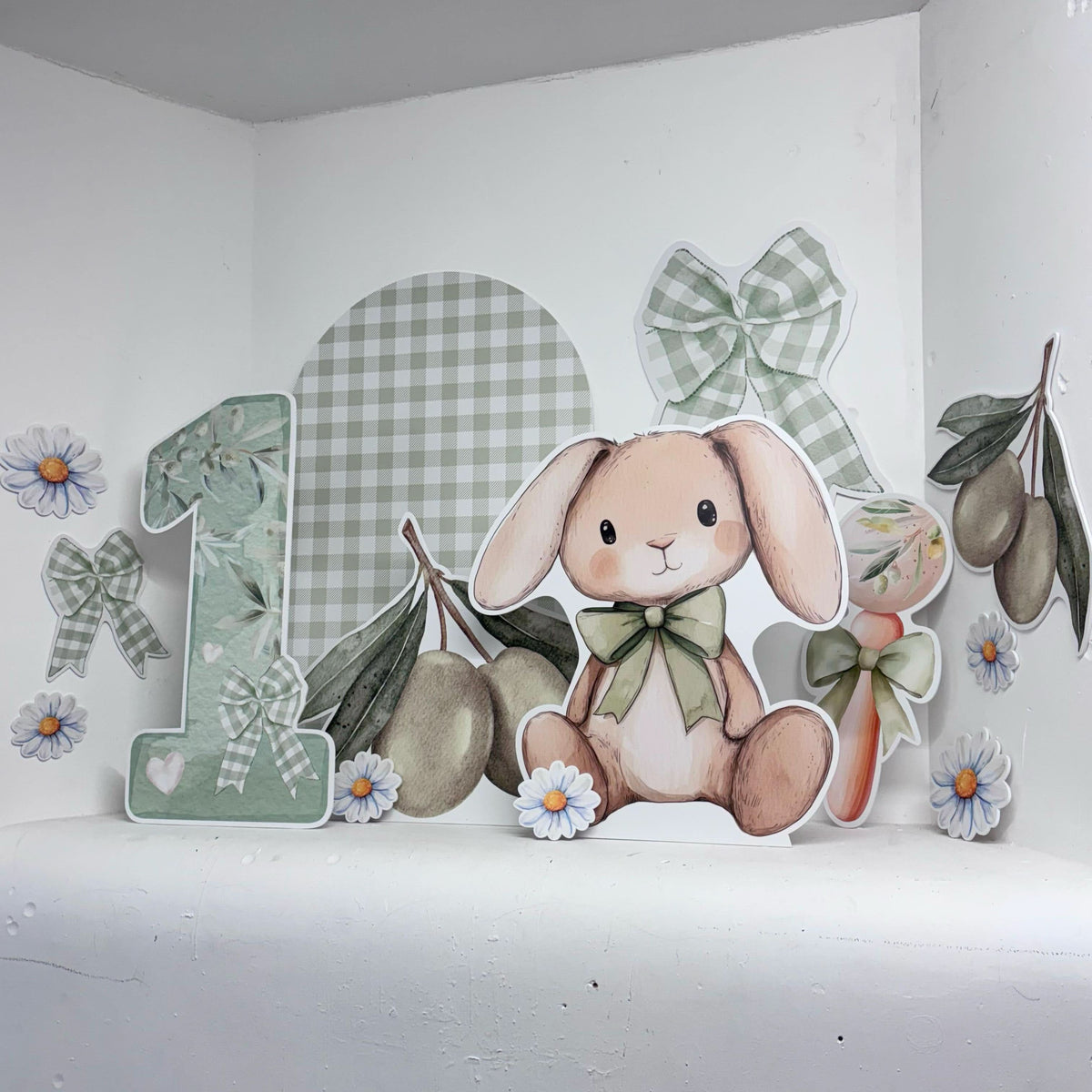 I Olive You Bundle featuring personalised waterproof foamex cutouts including bunny with bow tie, number one, green gingham sailboard, olive branches, daisies, and gingham bows first birthday party decorations