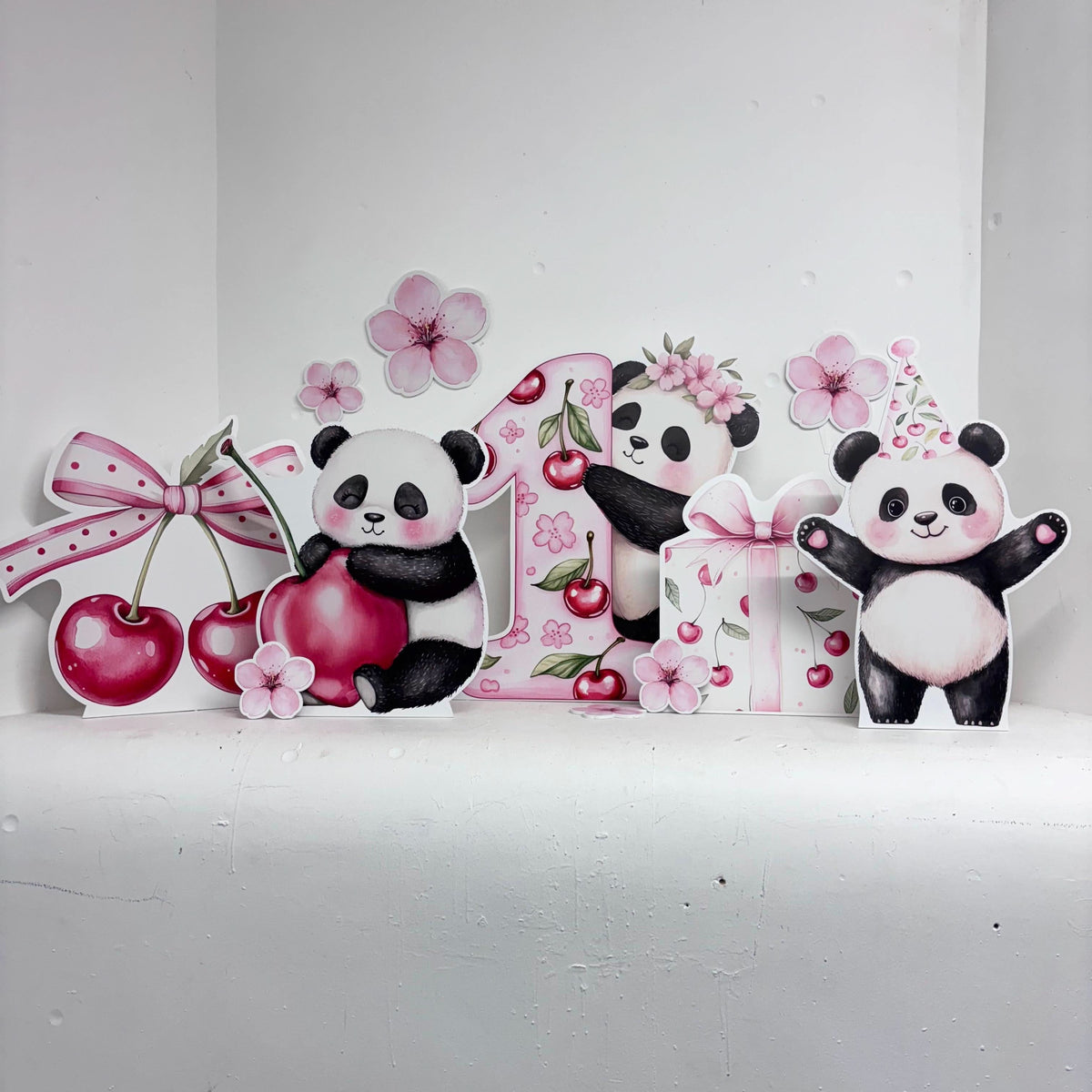 Mini Cherry First Birthday Bundle featuring personalised waterproof foamex cutouts including pandas with number one, cherries, cherry blossoms, and pink bow decorations