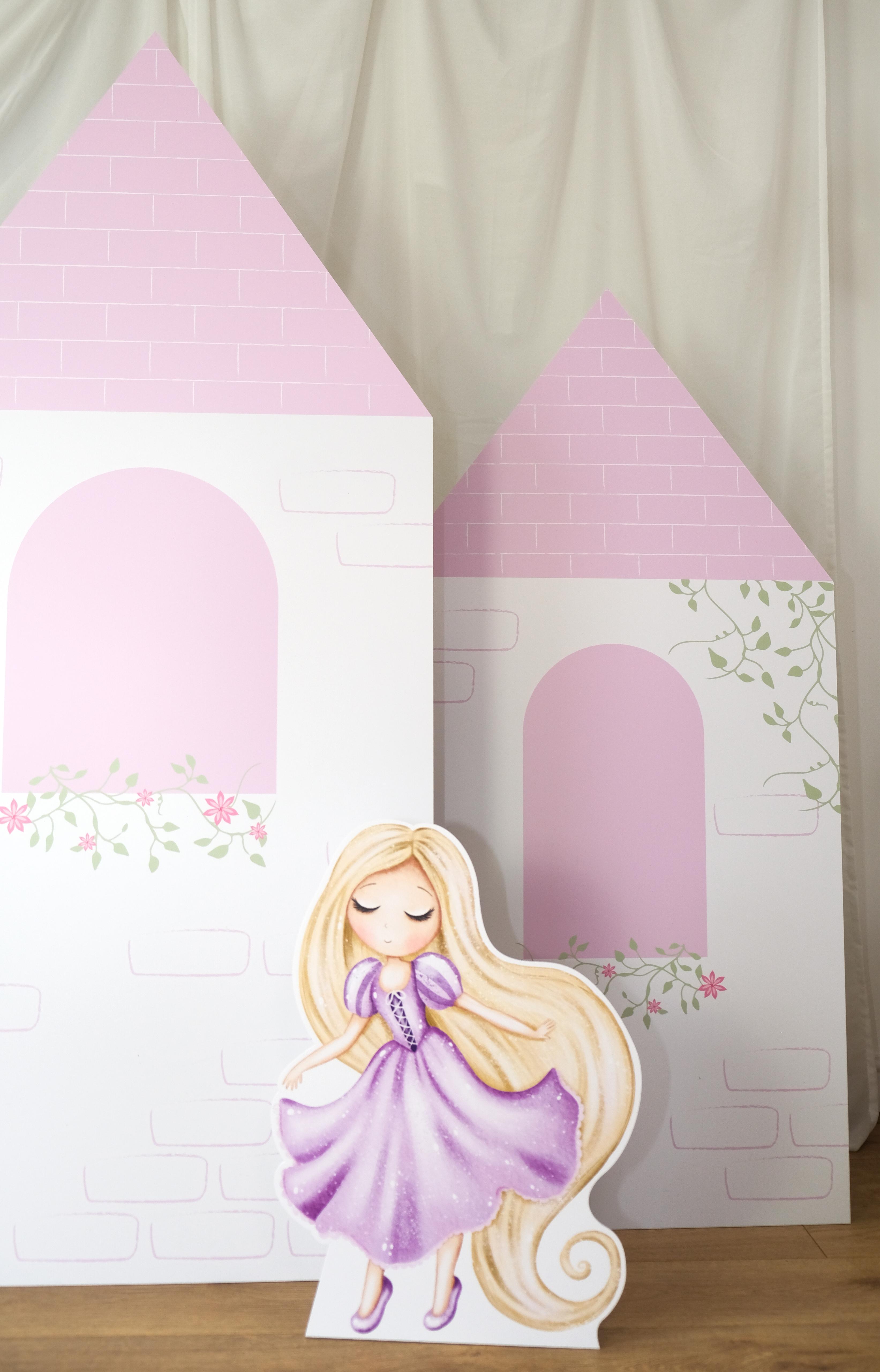 Close-up of Floral Bloom Castle waterproof foamex castle showing pink roofs, arched doorway, floral vine details, and princess cutout displayed in front party prop