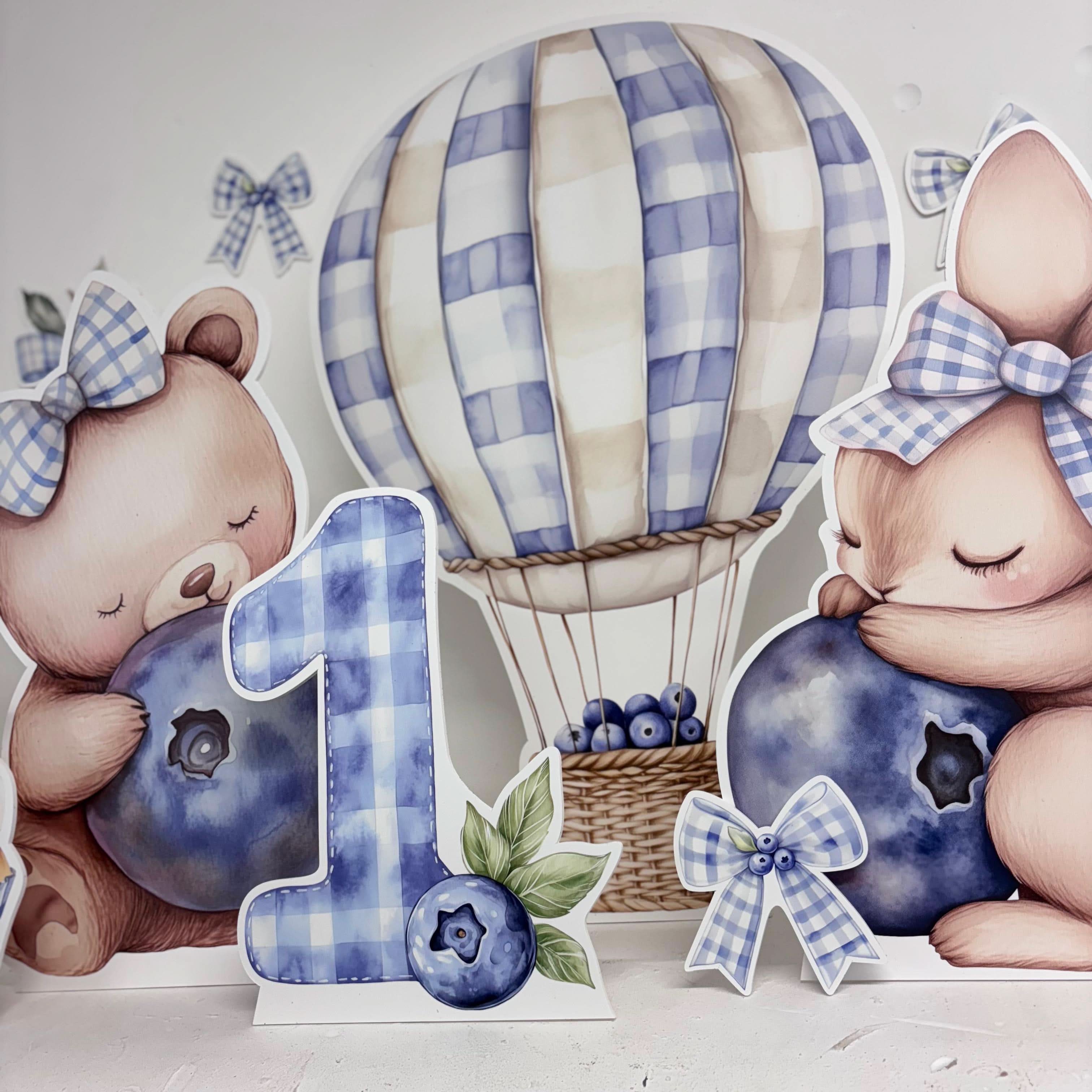 Mini Blue Berry First Birthday Bundle featuring personalised waterproof foamex cutouts including teddy bear, hot air balloon, and bunny with blueberry decorations