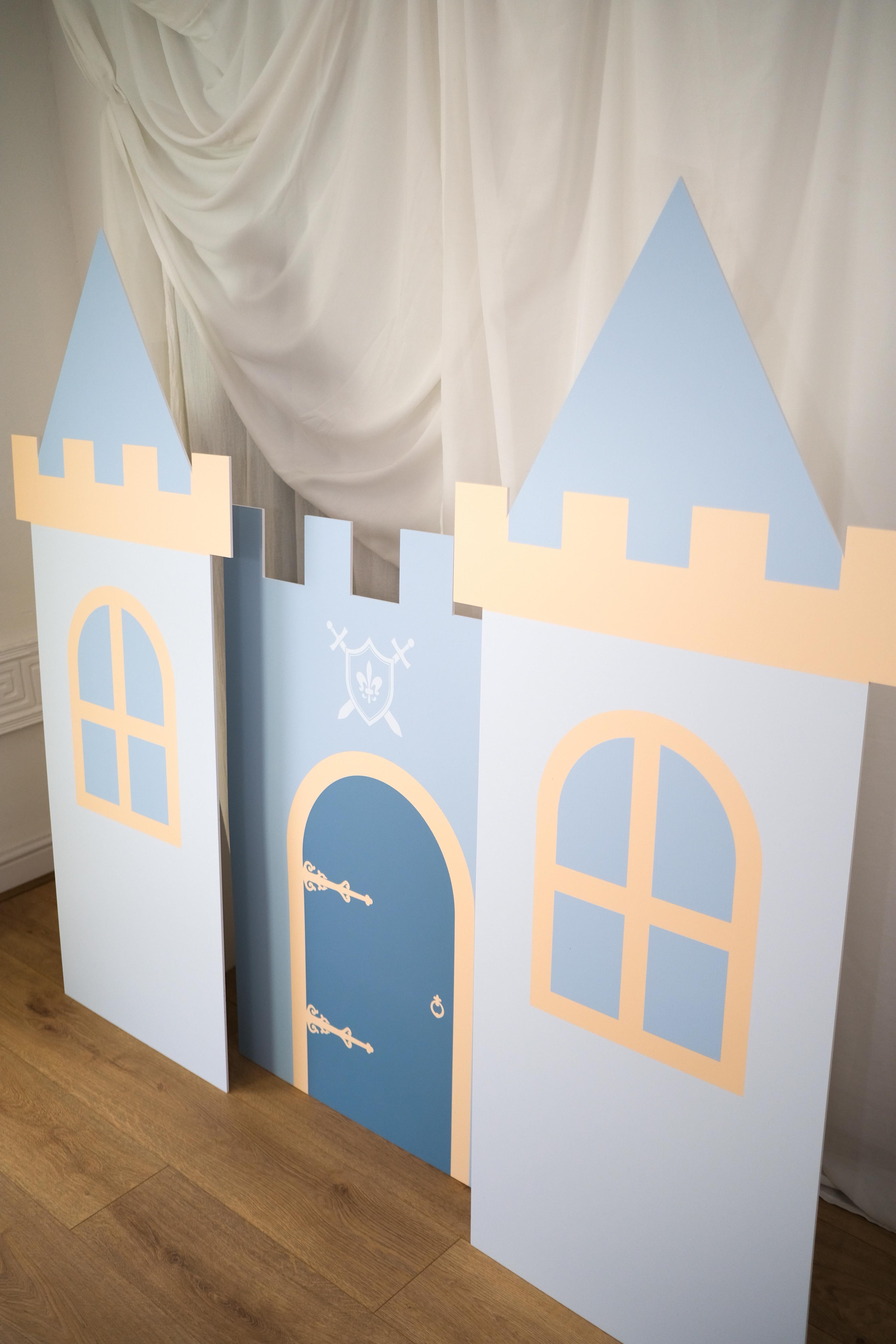 Side angle of Knight Castle waterproof foamex castle set showing side tower with blue door, arched windows, and middle tower battlements medieval knight party prop