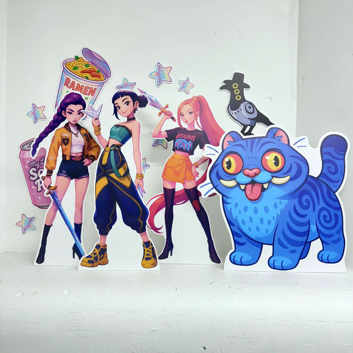 Mini Girl Demon Hunters Bundle featuring personalised waterproof foamex cutouts including three anime-style girl warriors with weapons, blue tiger creature, ramen bowl, and star decorations