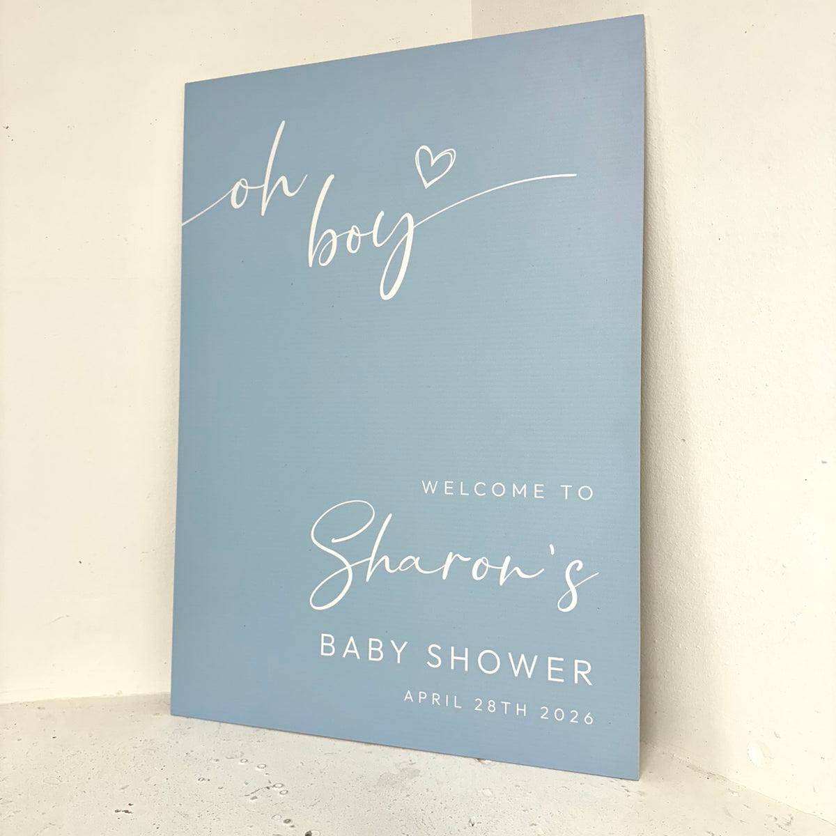 Oh Boy baby shower foamex easel board angled view showing elegant calligraphy and personalised details for a boy's baby shower