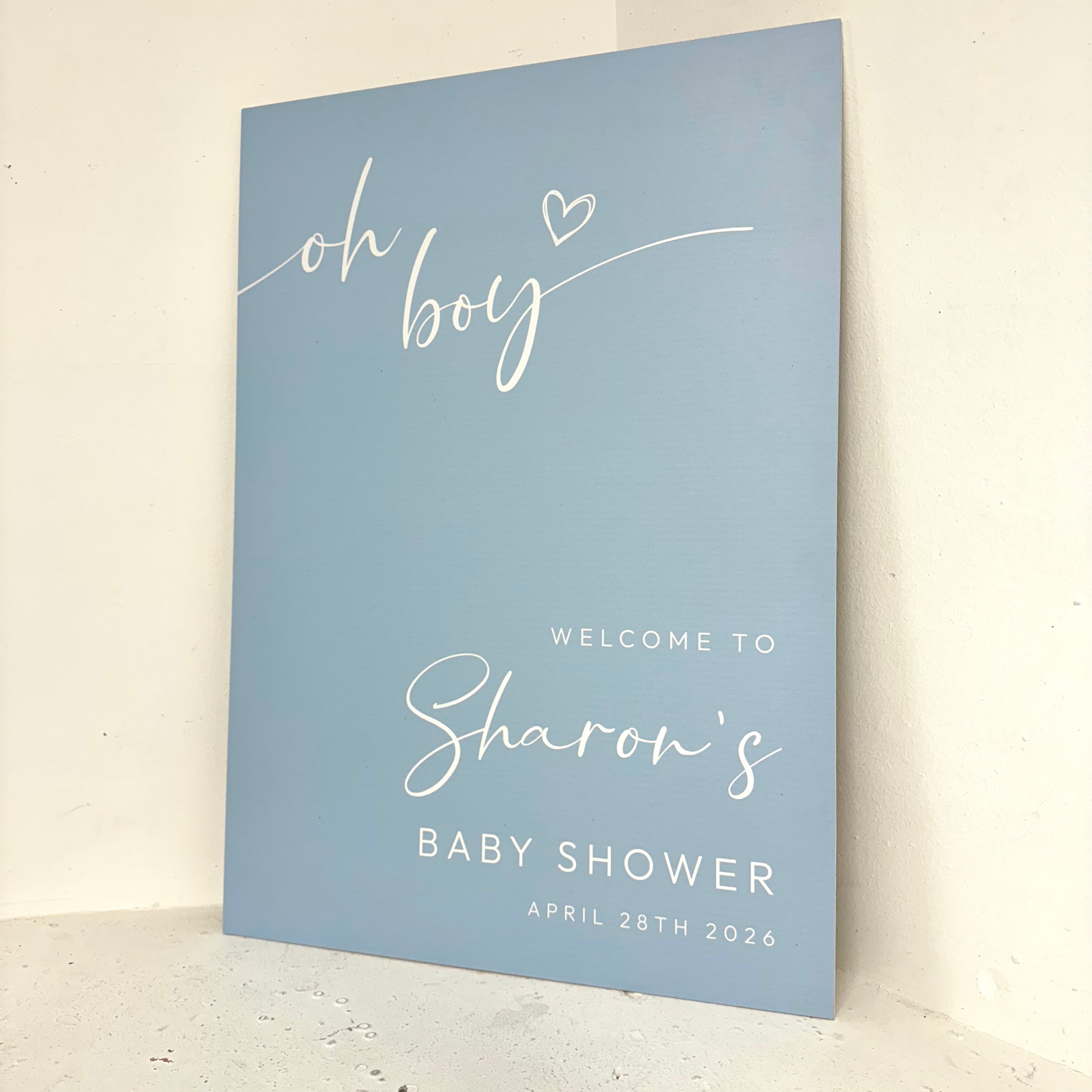 Oh Boy baby shower foamex easel board angled view showing elegant calligraphy and personalised details for a boy's baby shower