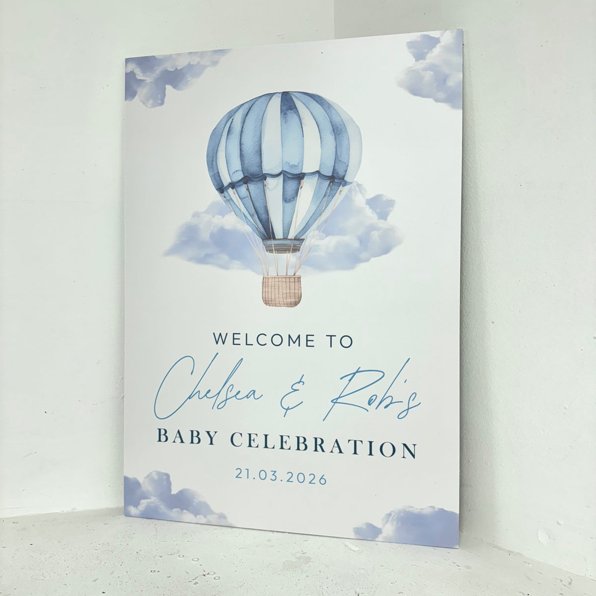 Angled close-up of blue hot air balloon and clouds baby shower foamex welcome board showing personalised calligraphy details