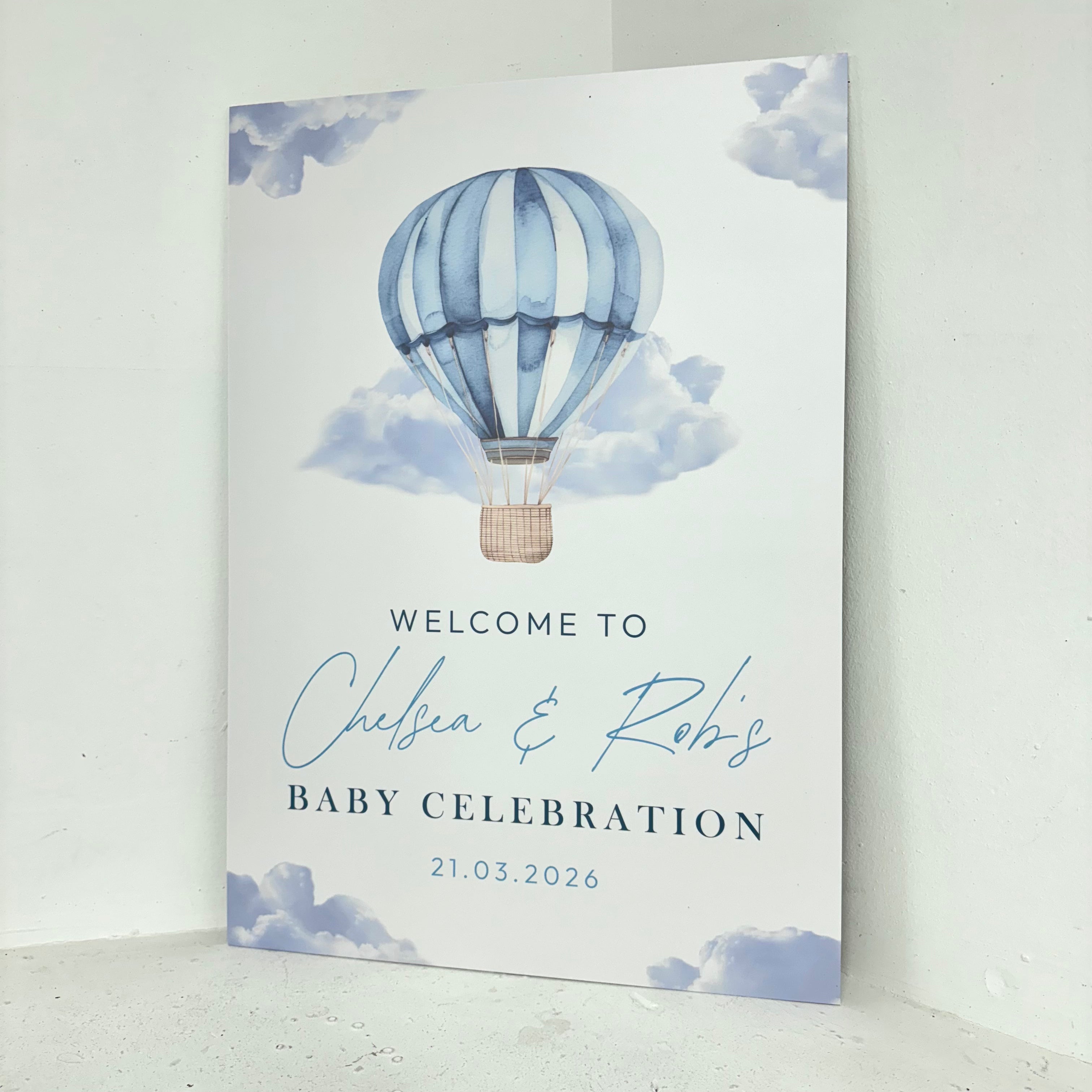 Angled close-up of blue hot air balloon and clouds baby shower foamex welcome board showing personalised calligraphy details