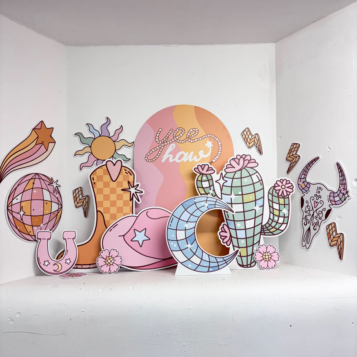 Disco Rodeo Bundle featuring personalised waterproof foamex cutouts including retro cactus, cowboy boot, disco balls, howdy sailboard, shooting star, sun, lightning bolts, and horseshoe party decorations