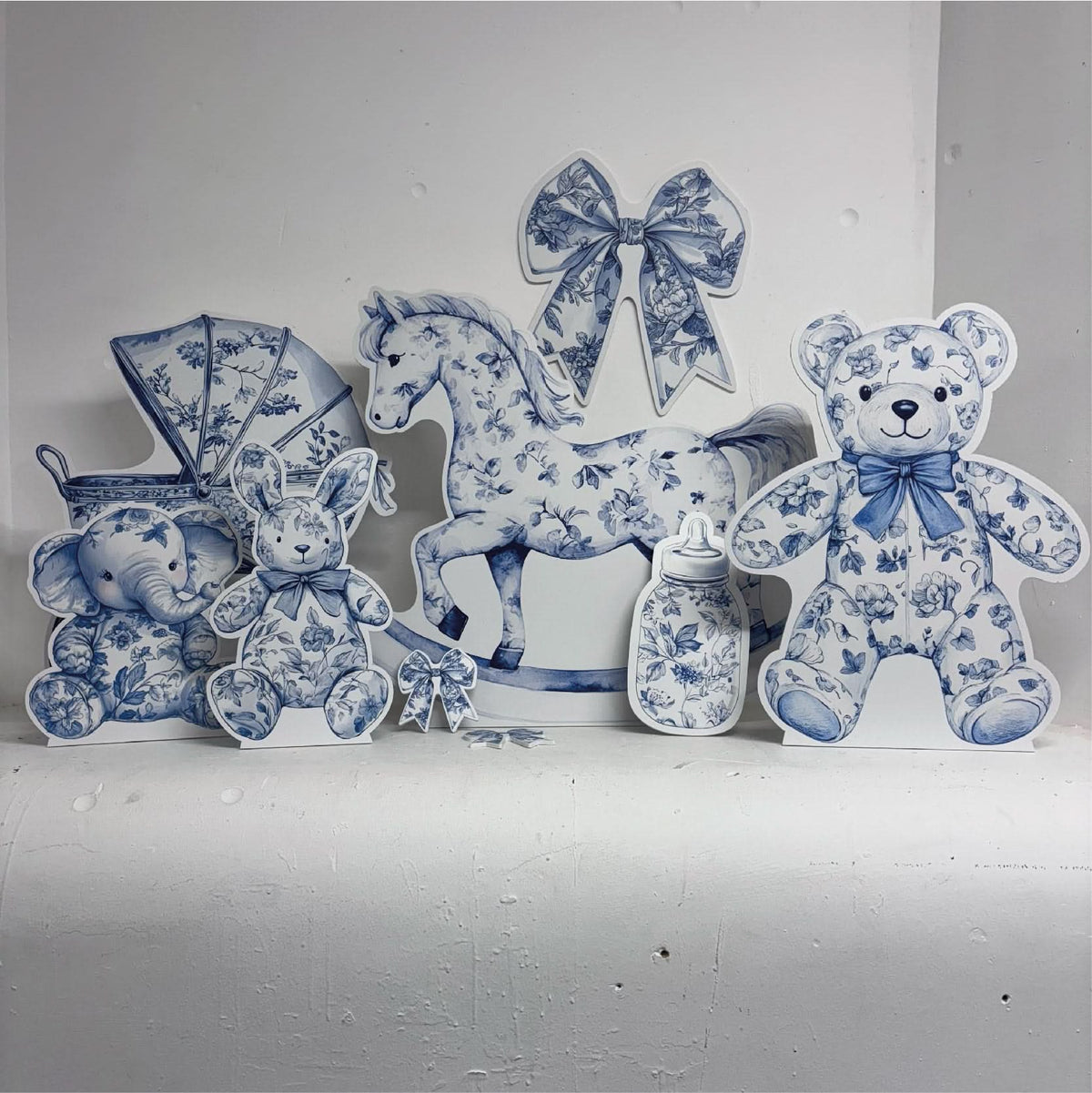 Mini Blue Baby Set Bundle featuring personalised waterproof foamex cutouts including blue floral rocking horse, stroller, teddy bear, bows, and baby bottle decorations