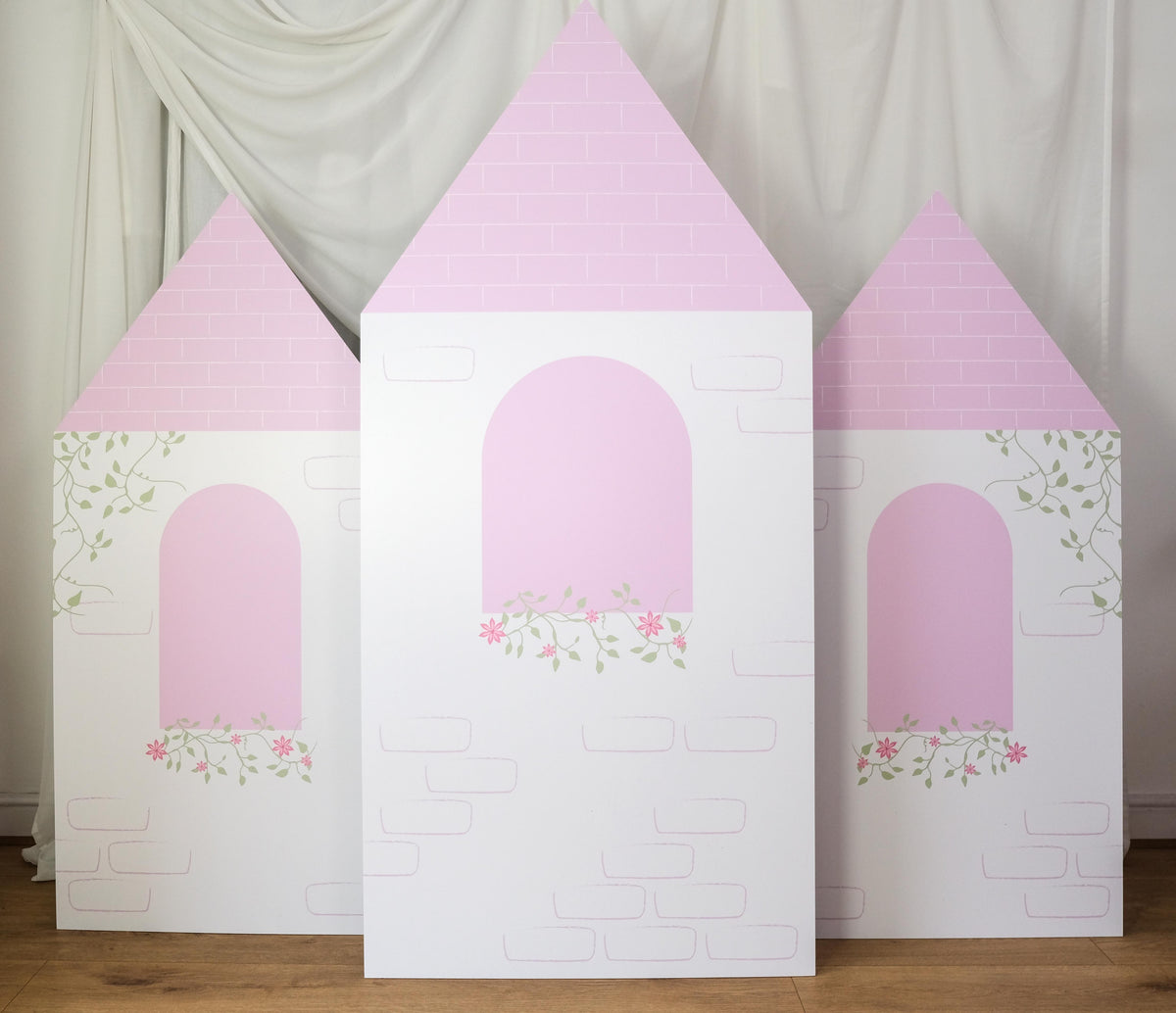 Front view of Floral Bloom Castle waterproof foamex castle set showing all three towers with pink roofs, arched windows, and floral details princess party prop