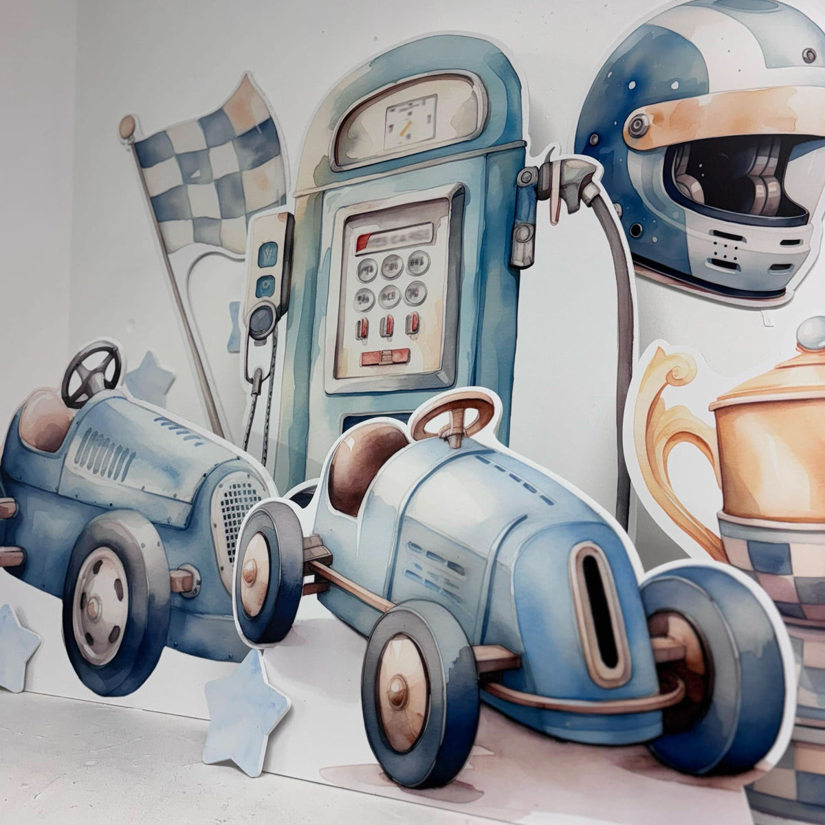 Close-up of Mini Blue Race Car waterproof foamex cutouts showing vintage race cars, petrol pump, checkered flag, racing helmet, and trophy party decorations