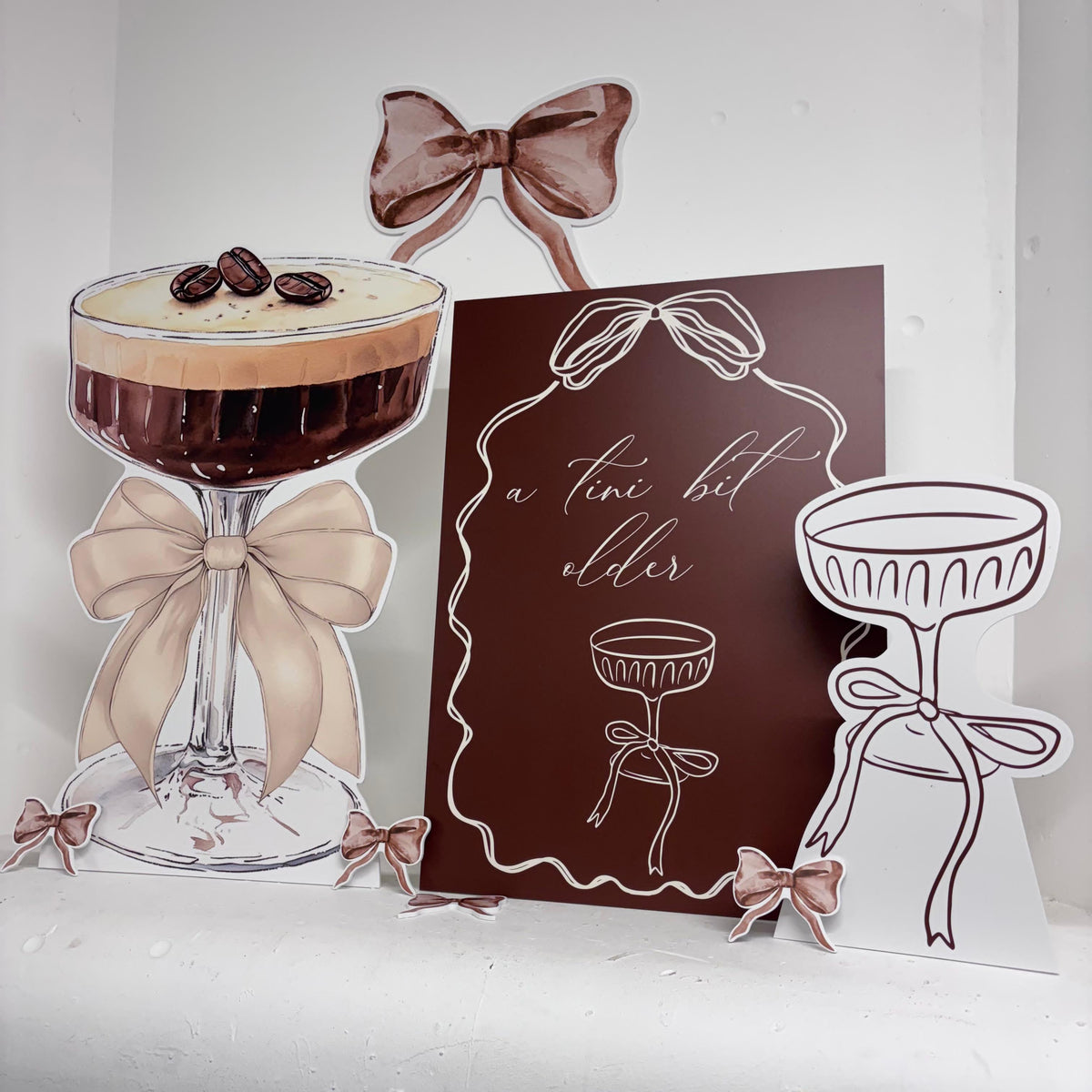 Mini Tini Bit Older Bundle featuring personalised waterproof foamex cutouts including espresso martini glass, a tini bit older sign, mini martini, bows, and coffee bean decorations