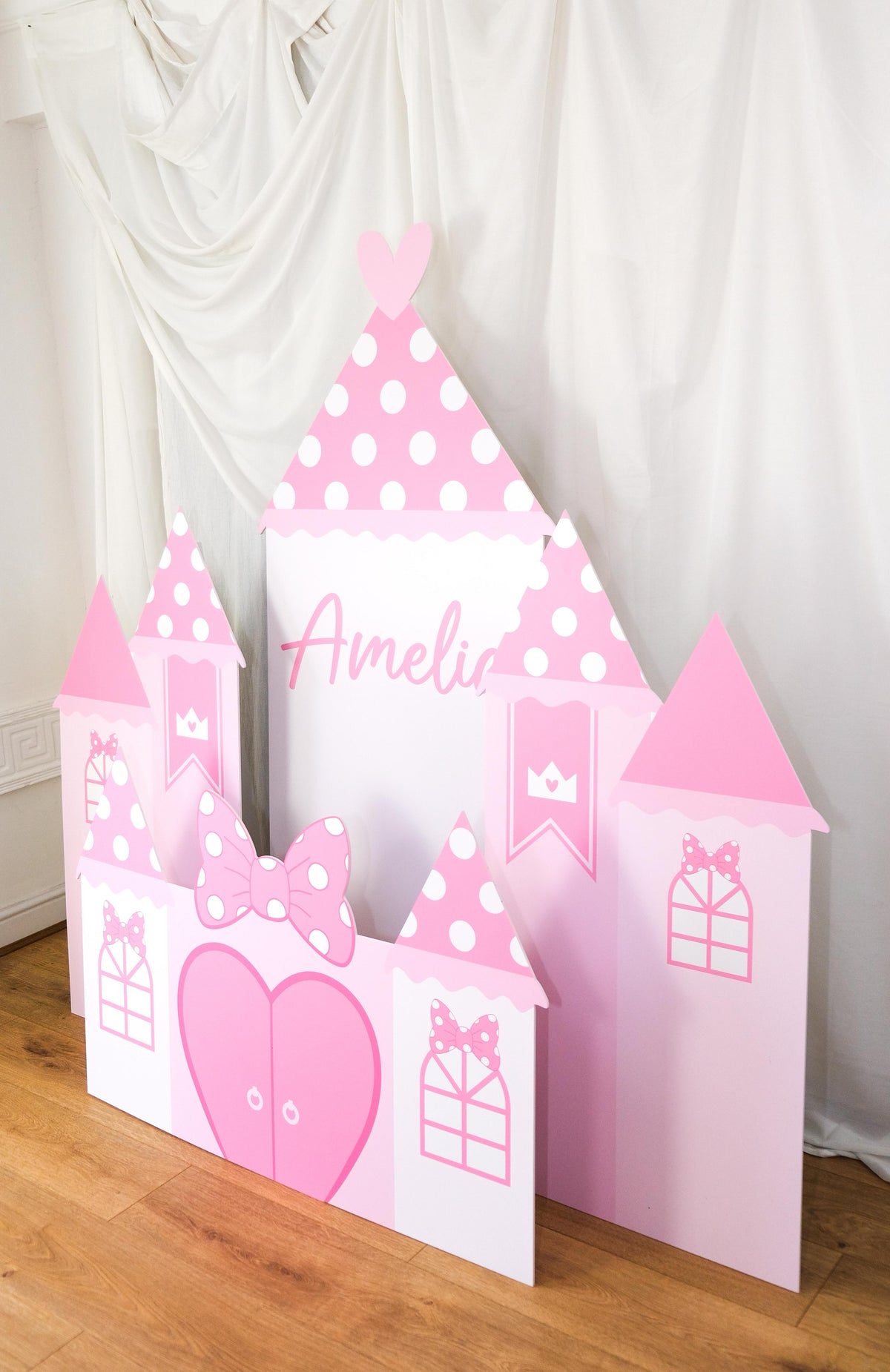 Close-up of Pink Mouse Castle waterproof foamex castle showing personalised Amelia name, polka dot turrets, pink bow, heart, and present box details princess party prop