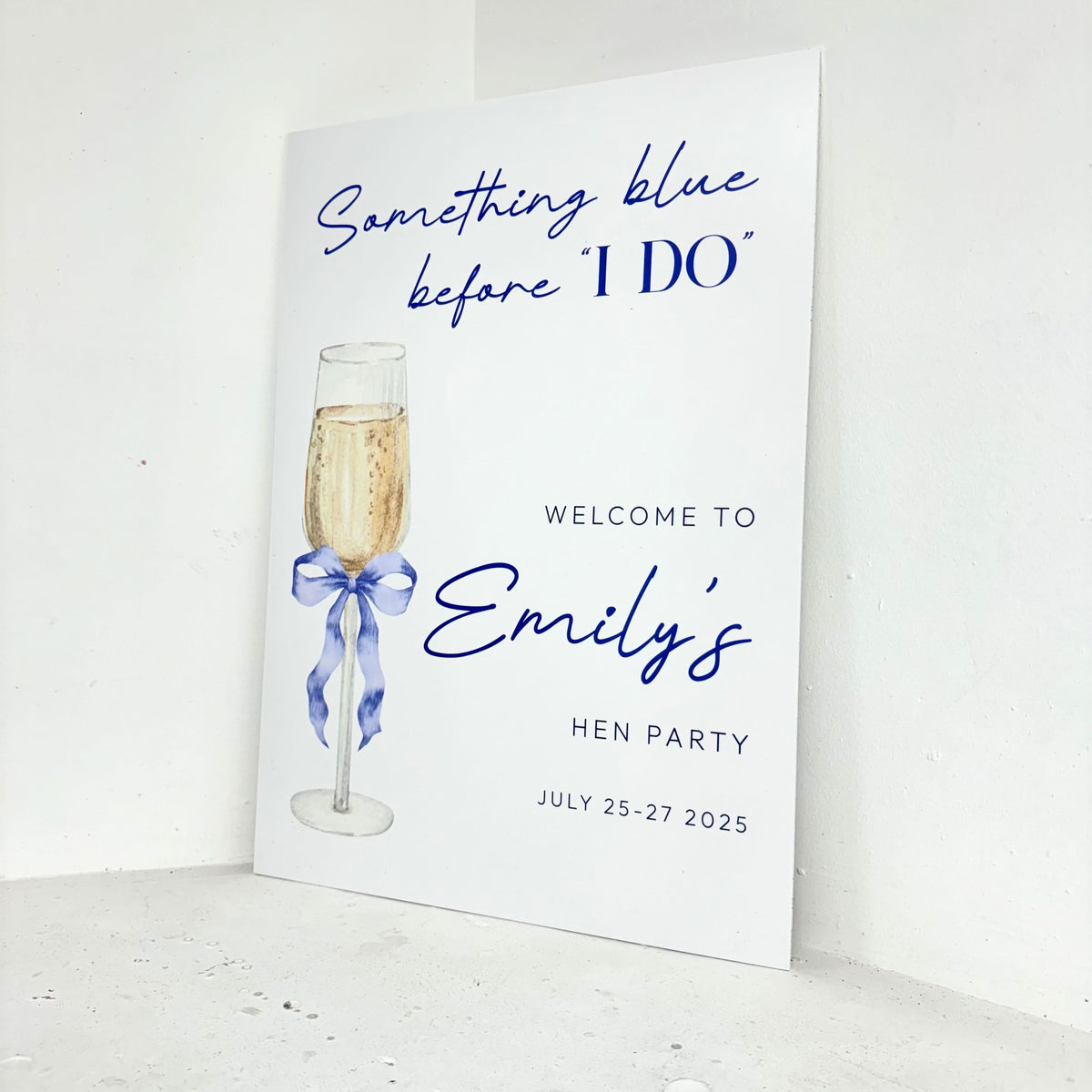Close-up of Something Blue Before I Do personalised hen party welcome sign with customisable name and date on freestanding foamex board