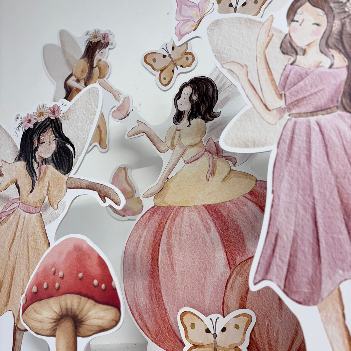 Close-up of Mini Enchanted Fairies waterproof foamex cutouts showing pink fairy, yellow fairy on mushroom, pumpkin fairy with butterflies and toadstool details