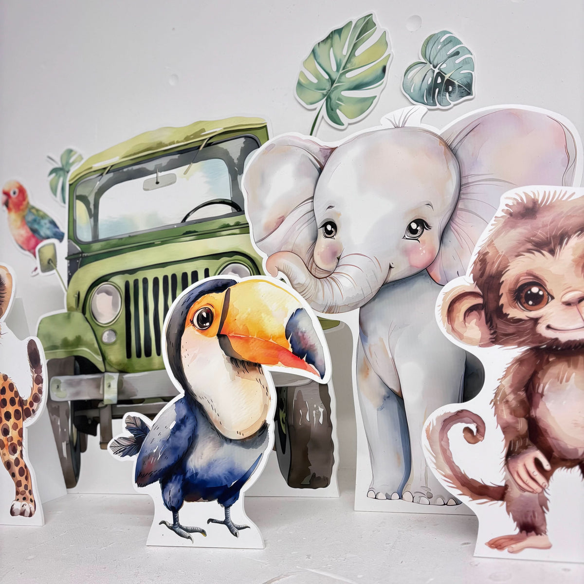 Close-up of Mini Jungle Bundle waterproof foamex cutouts showing toucan, elephant, monkey, jeep, and giraffe with tropical leaves