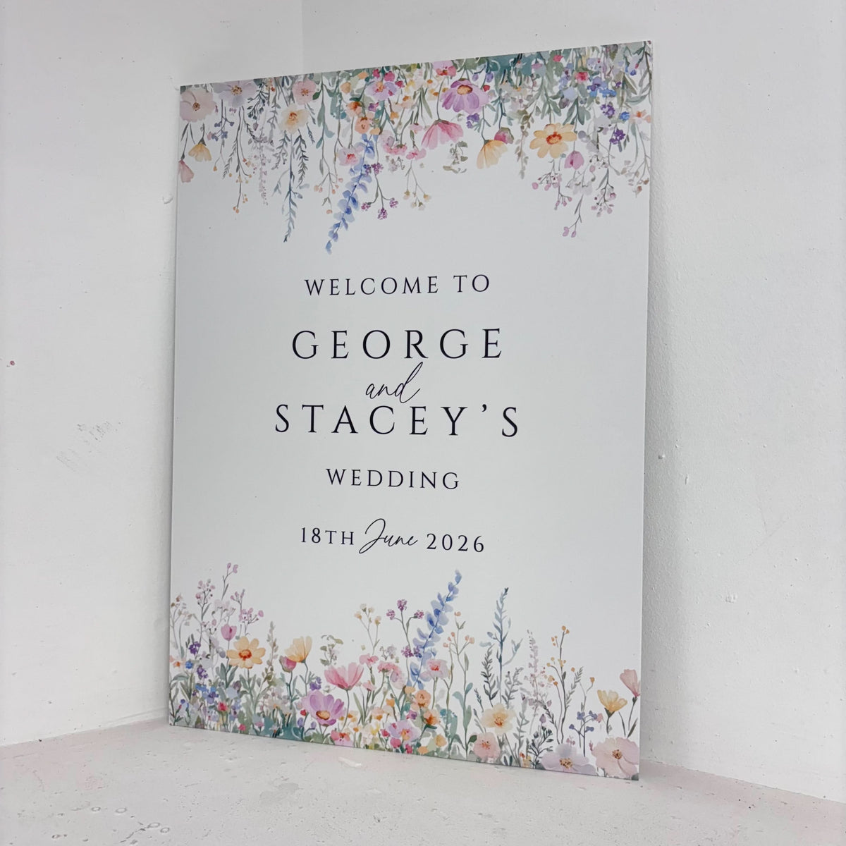 Floral Wedding easel sign angled view showing wildflower design with personalised couple names and wedding date on freestanding foamex board