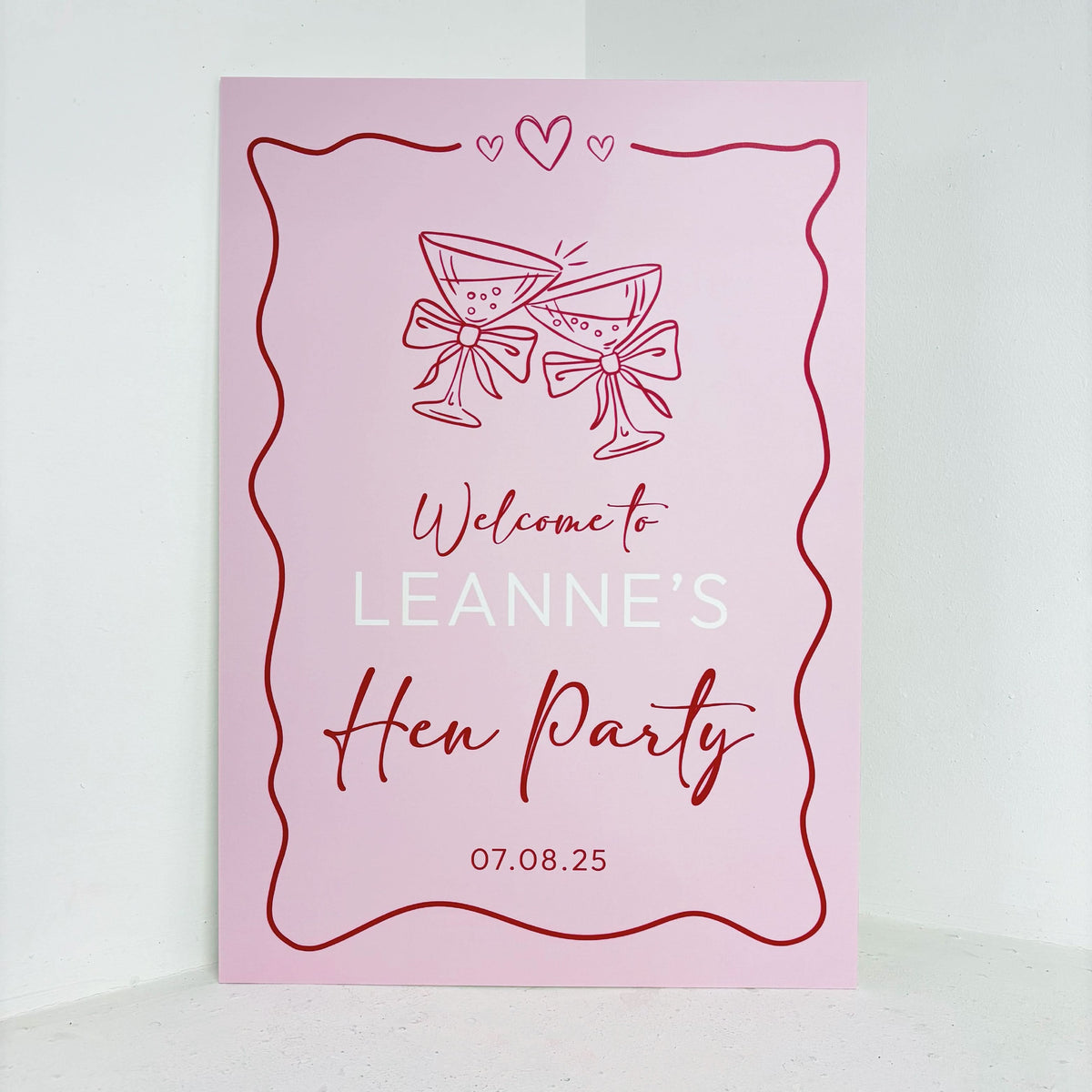Hen Party personalised easel sign in pink with cocktail glass illustrations, hearts and custom name on waterproof foamex board