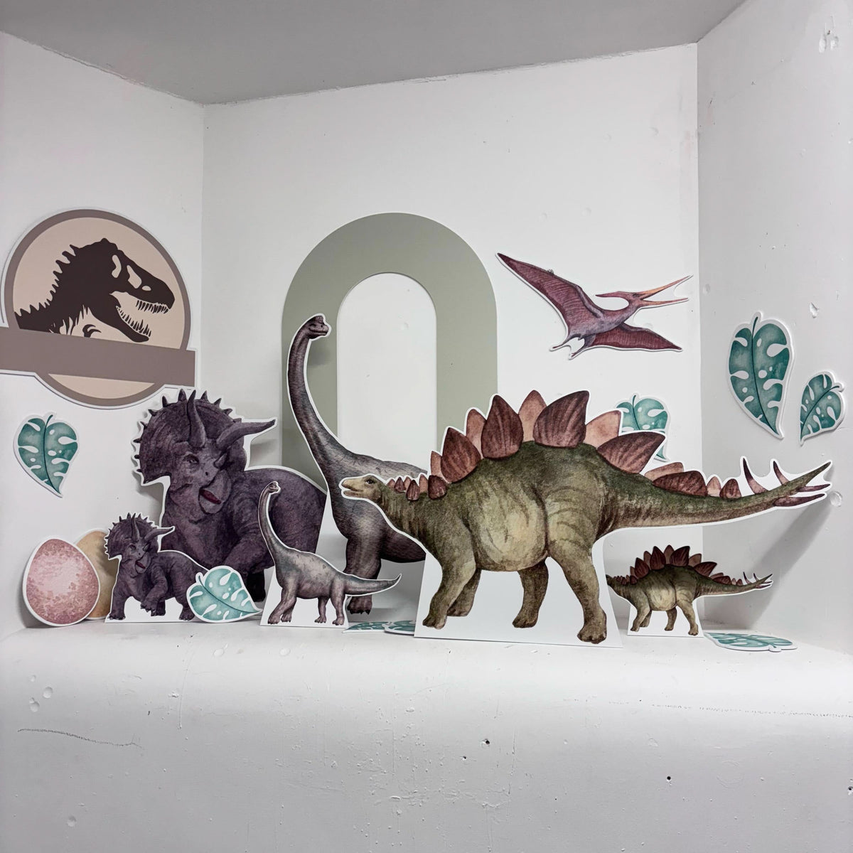 Dinosaur World Bundle featuring personalised waterproof foamex cutouts including brachiosaurus, stegosaurus, triceratops, pterodactyl, and green arch sail board decorations