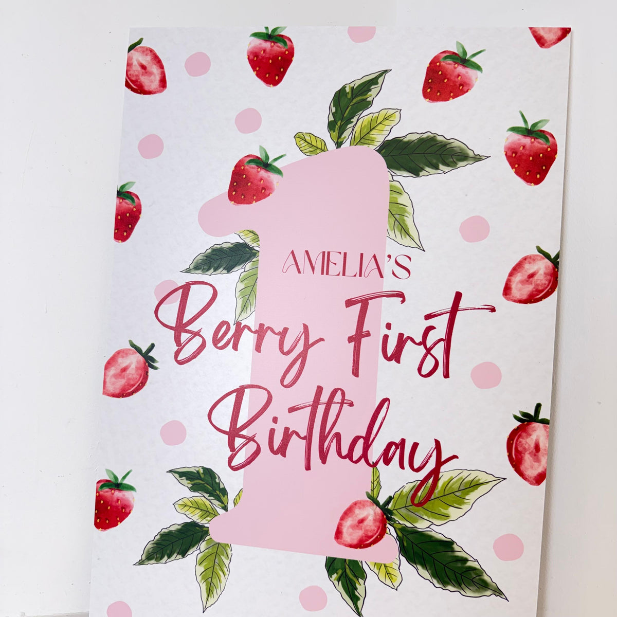 Personalised Berry First Birthday easel sign close-up with strawberries, polka dots, and custom name - 1st birthday party welcome sign by Zebra Print Events