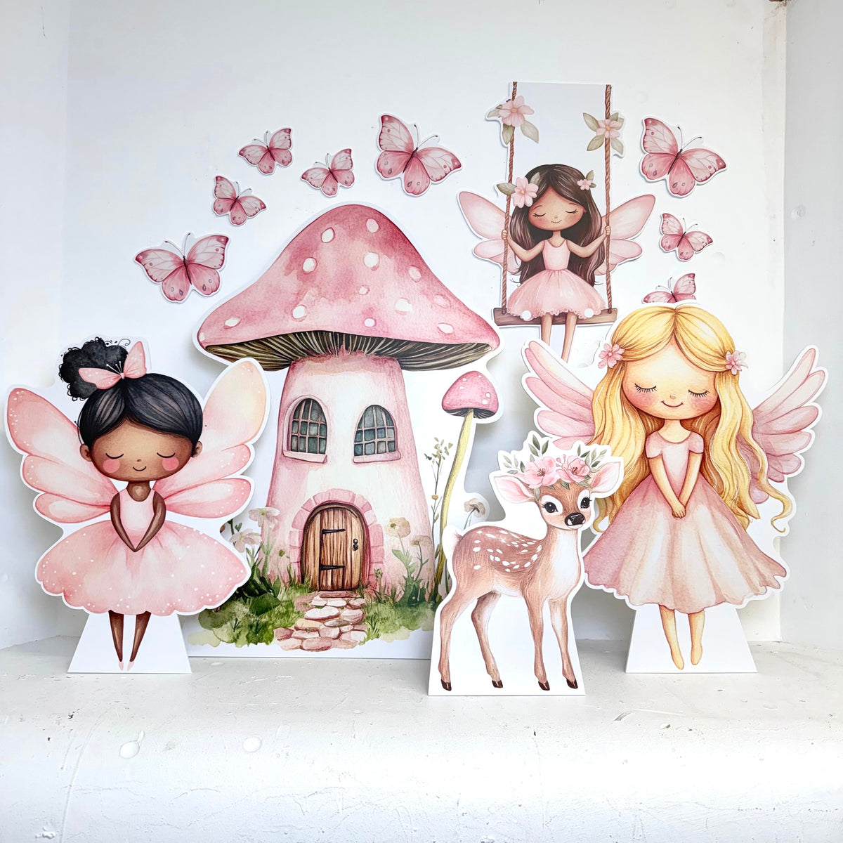 Alternative angle of Mini Pretty Pink Fairies waterproof foamex cutouts showing mushroom house, blonde fairy, brown haired fairy with pink butterflies and deer accessories