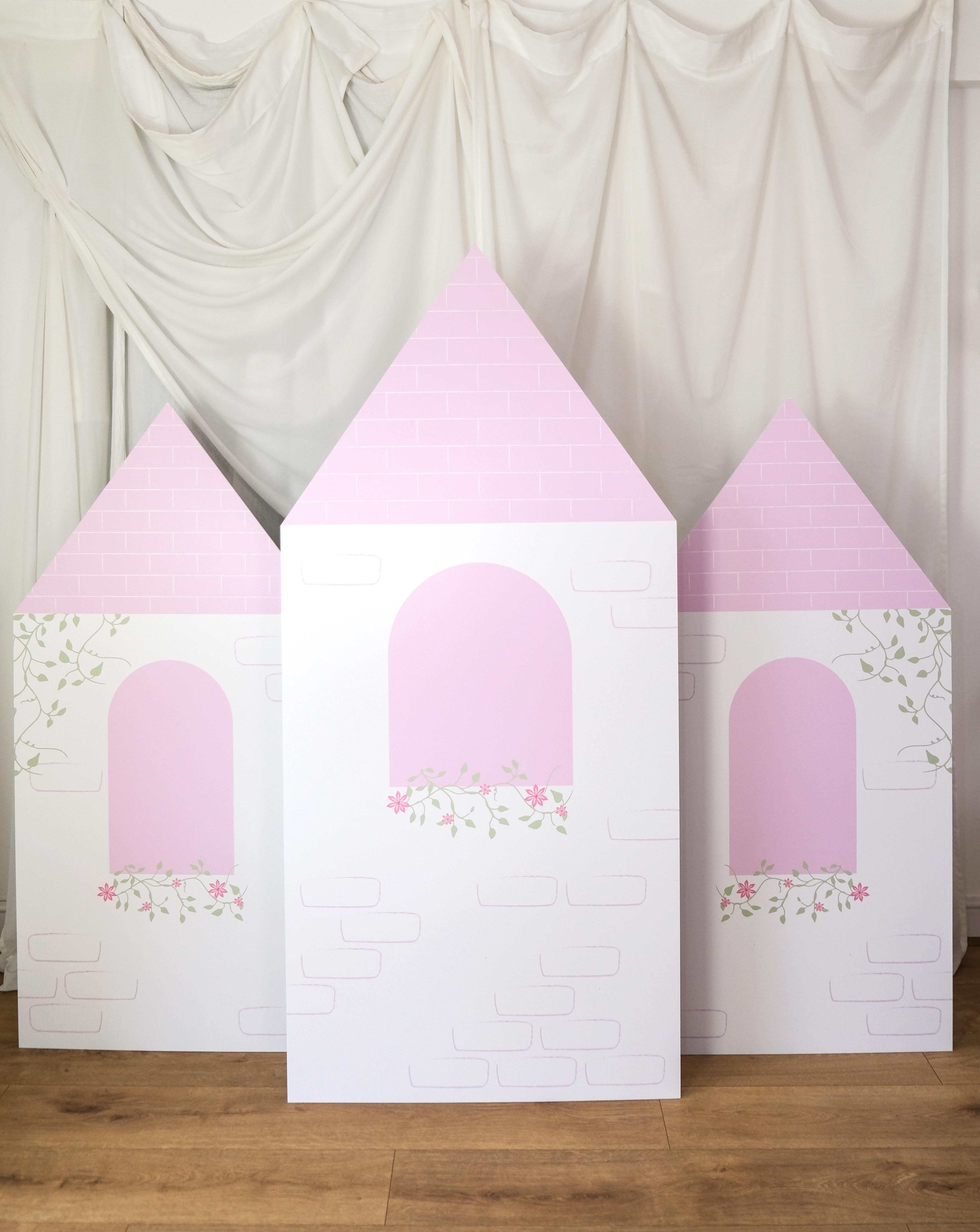 Angled view of Floral Bloom Castle waterproof foamex castle set showing middle tower and side towers with pink roofs, arched windows, and floral details princess party prop