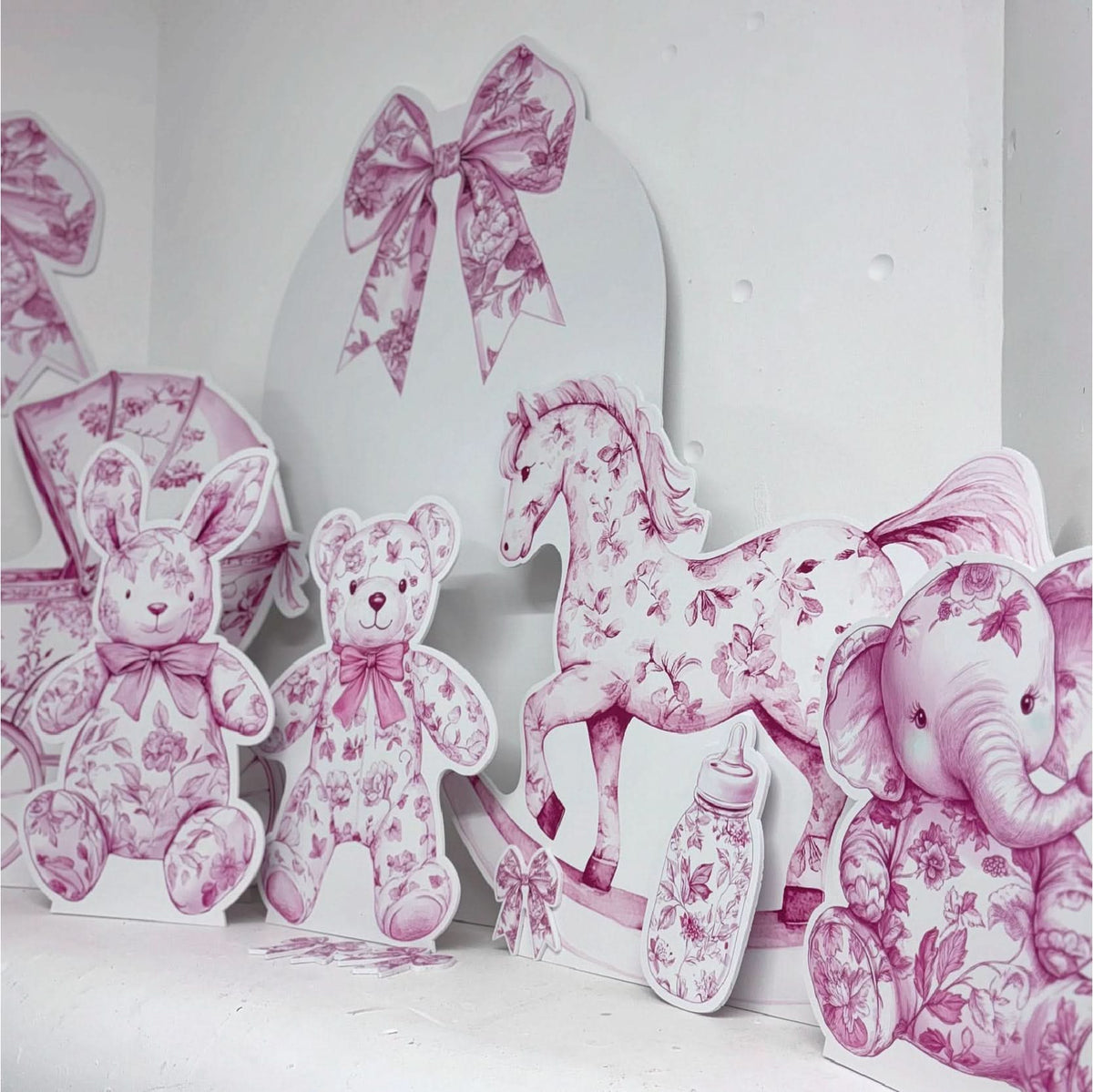 Pink Baby Set Bundle featuring personalised waterproof foamex cutouts including pink floral teddy bear, bunny, rocking horse, elephant, stroller, bows, and sail board baby shower decorations