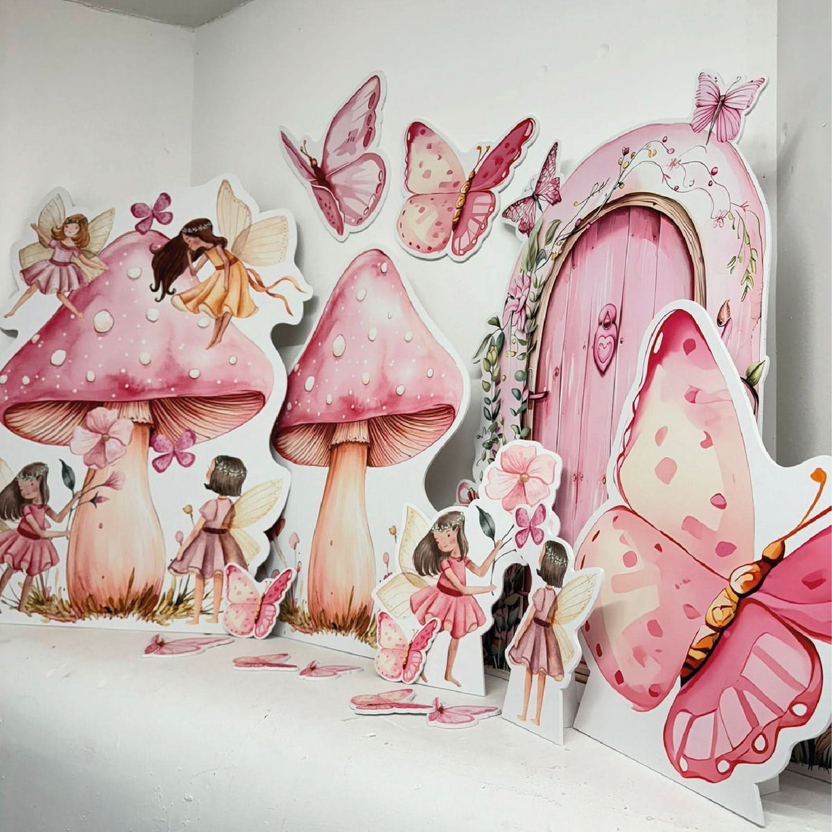 Pink Butterfly Fairy Garden Bundle featuring personalised waterproof foamex cutouts including fairies on toadstools, pink fairy door, mushrooms, butterflies, and fairy garden party decorations